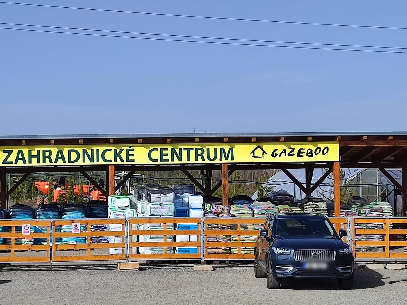 Vstup do Zahradnického centra Gazeboo se žlutou cedulí